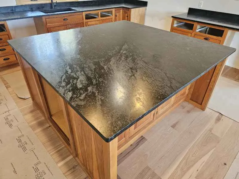 Black Smoke Vector honed soapstone on a large kitchen island with warm wood cabinetry
