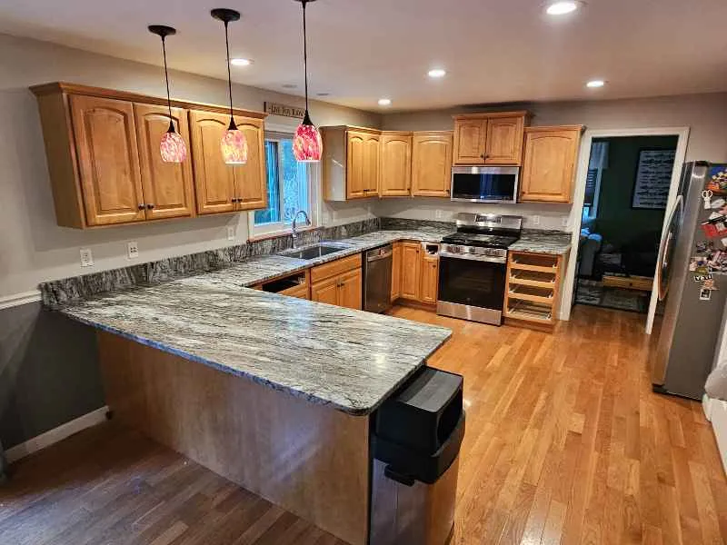 Blue Dunes granite countertops on an island and perimeter in a Barrington New Hampshire kitchen