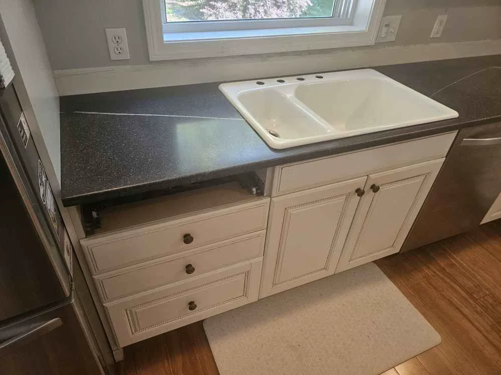 Drop-in double-bowl sink installed in a dark granite countertop in Chichester, NH