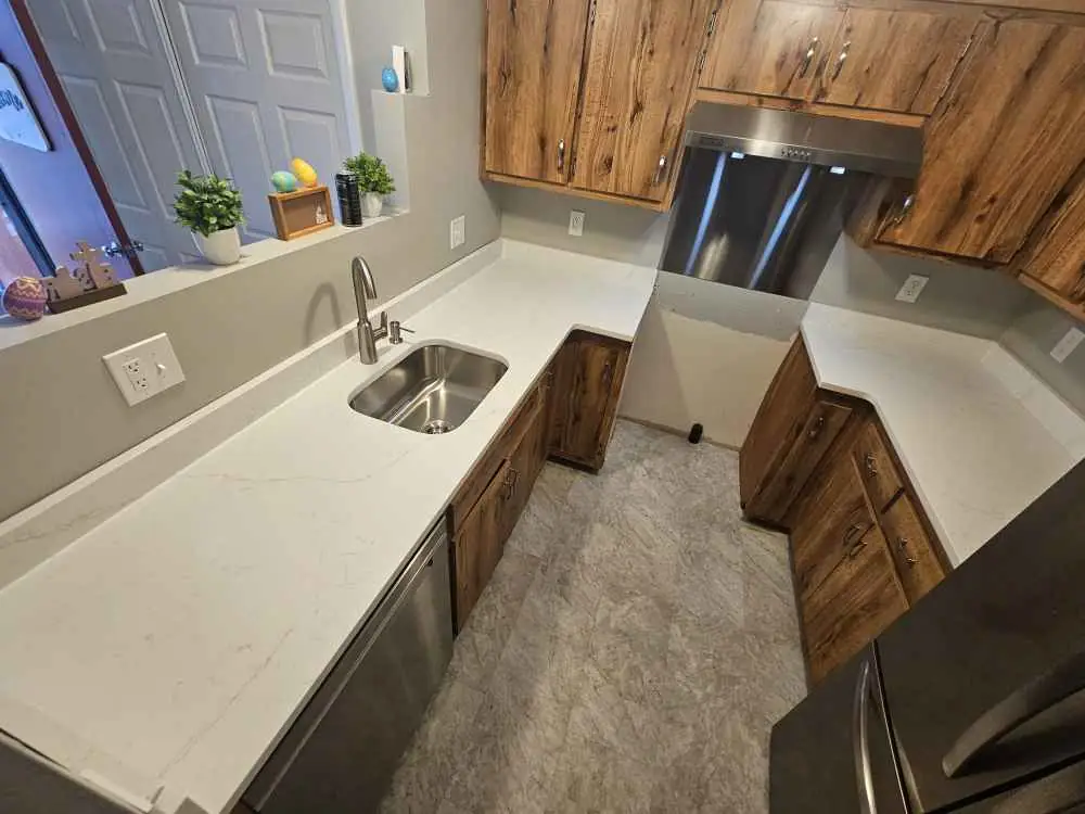 Calacatta Rusta Quartz Kitchen Remodel in Pembroke, NH by Precision Granite Works project photo