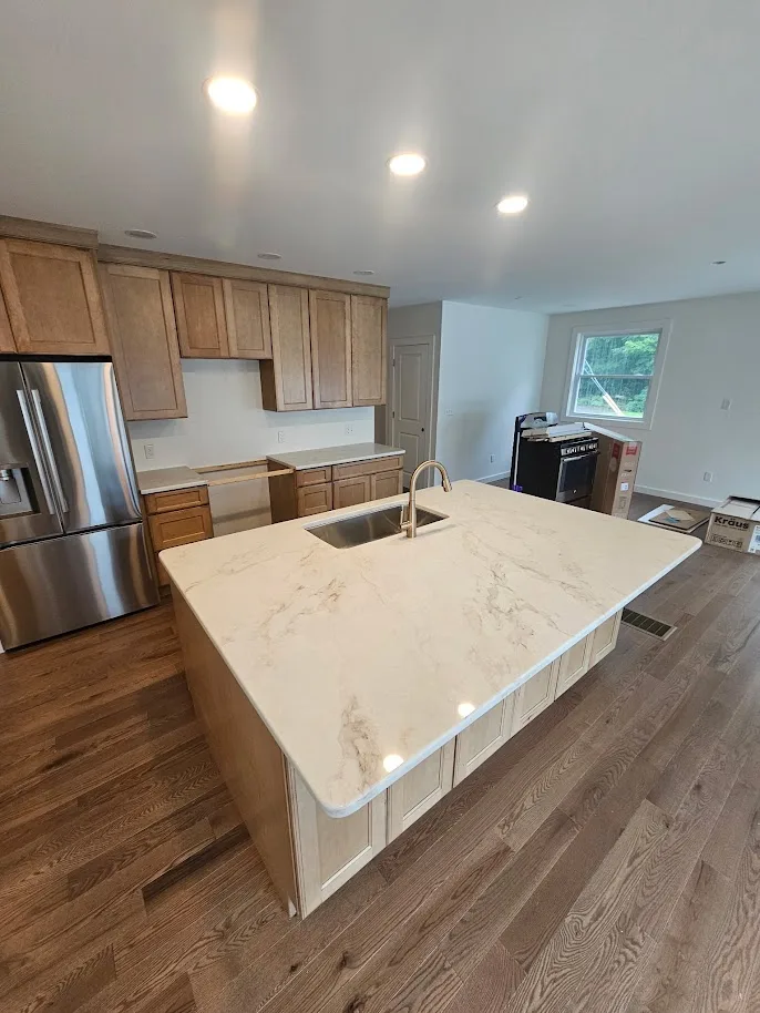 Natural stone kitchen island countertop with warm veining — installed by Precision Granite Works in New Hampshire