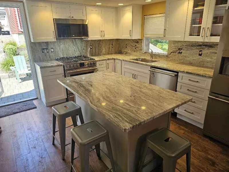 Natural stone kitchen island with broad movement and perimeter countertops