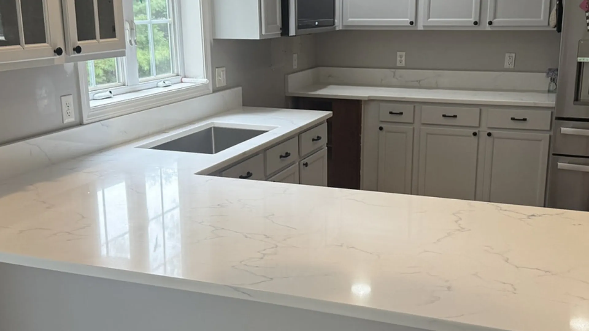 White quartz countertop in a New Hampshire kitchen — Precision Granite Works quartz repair specialists