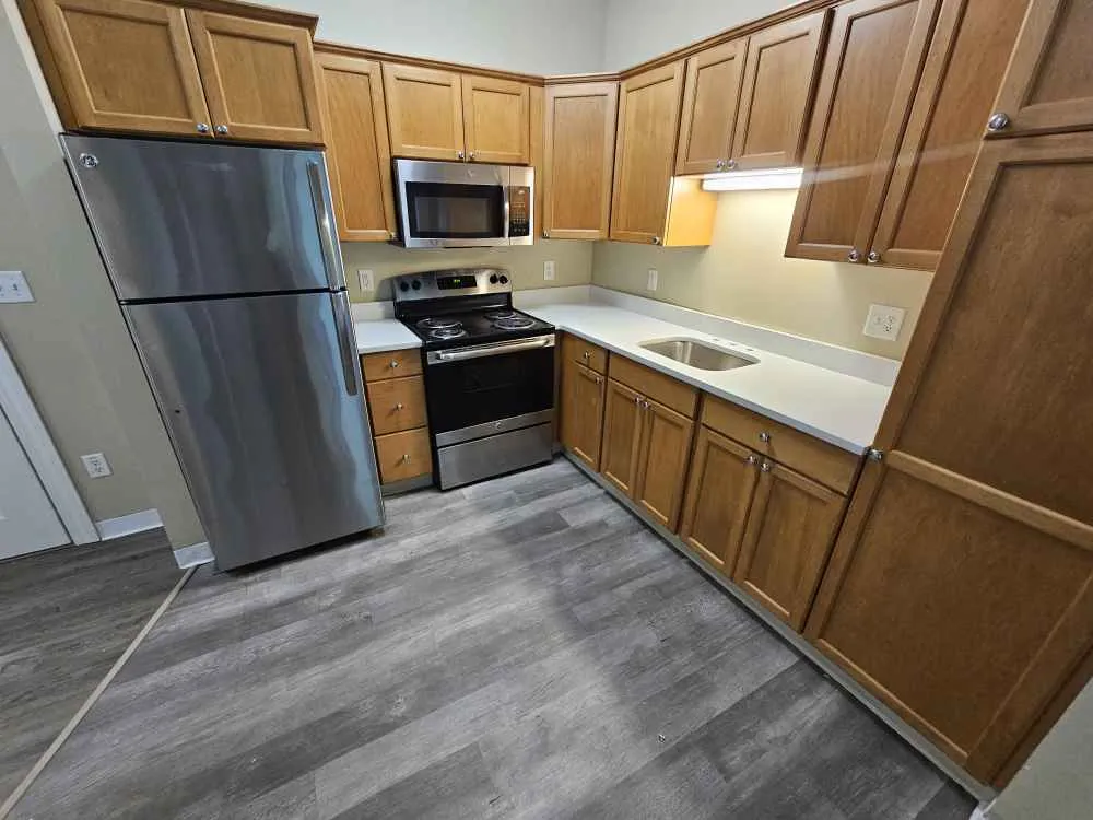Quartz remnant kitchen countertop with wood cabinetry in a Durham, New Hampshire home