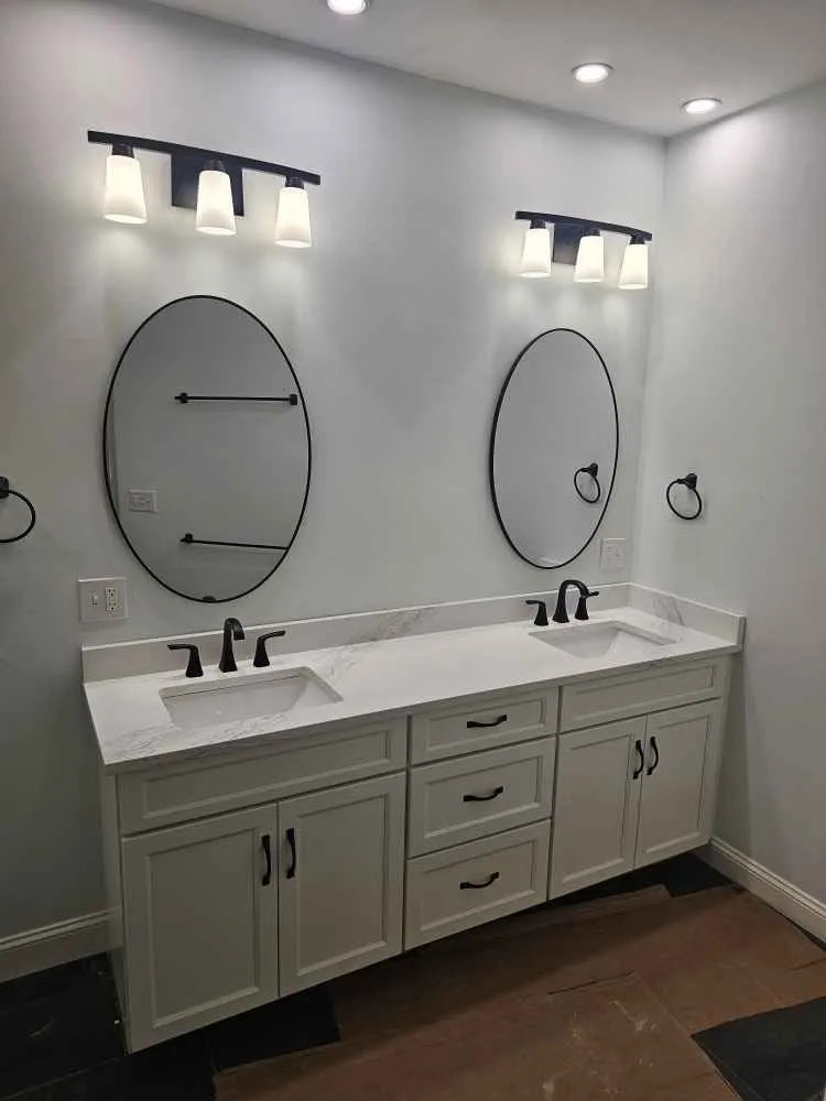 Quartz remnant vanity top countertop installed in a small bathroom in Manchester, NH