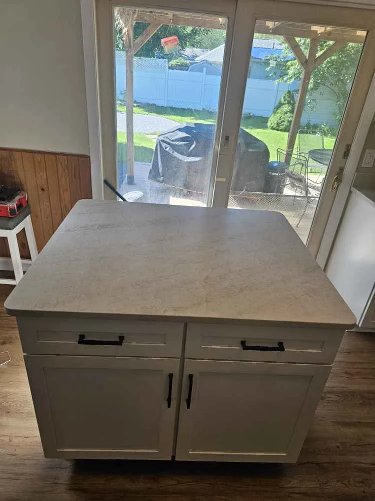 Taj Mahal quartzite kitchen island countertop surface showing soft cream tones and natural veining — Precision Granite Works NH
