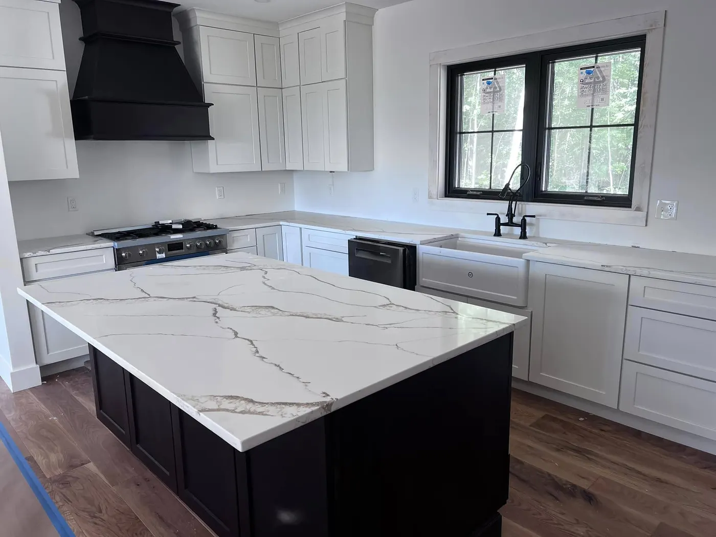 White kitchen island countertop with long gray and tan veins extending across the slab