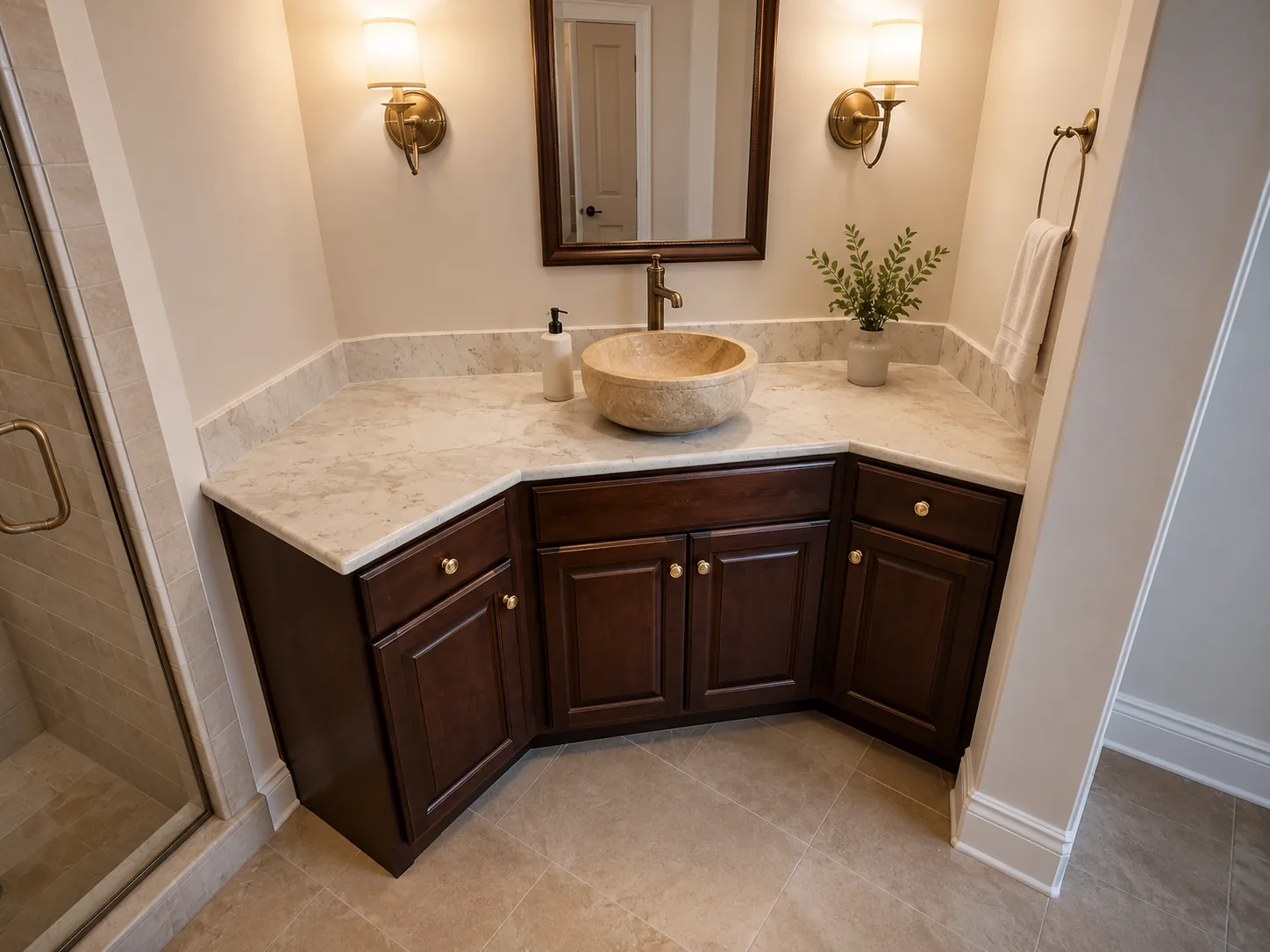 Stone vessel sink on a marble bathroom vanity countertop with dark wood cabinets — New Hampshire