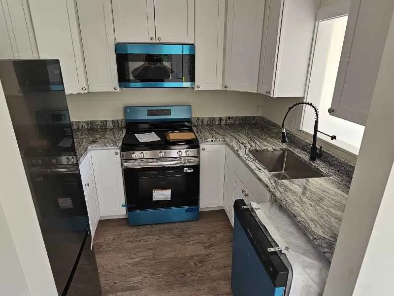 Viscount White granite countertops in a compact white kitchen in Rochester New Hampshire