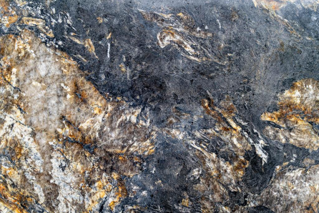 Dark quartzite slab with golden flecks.